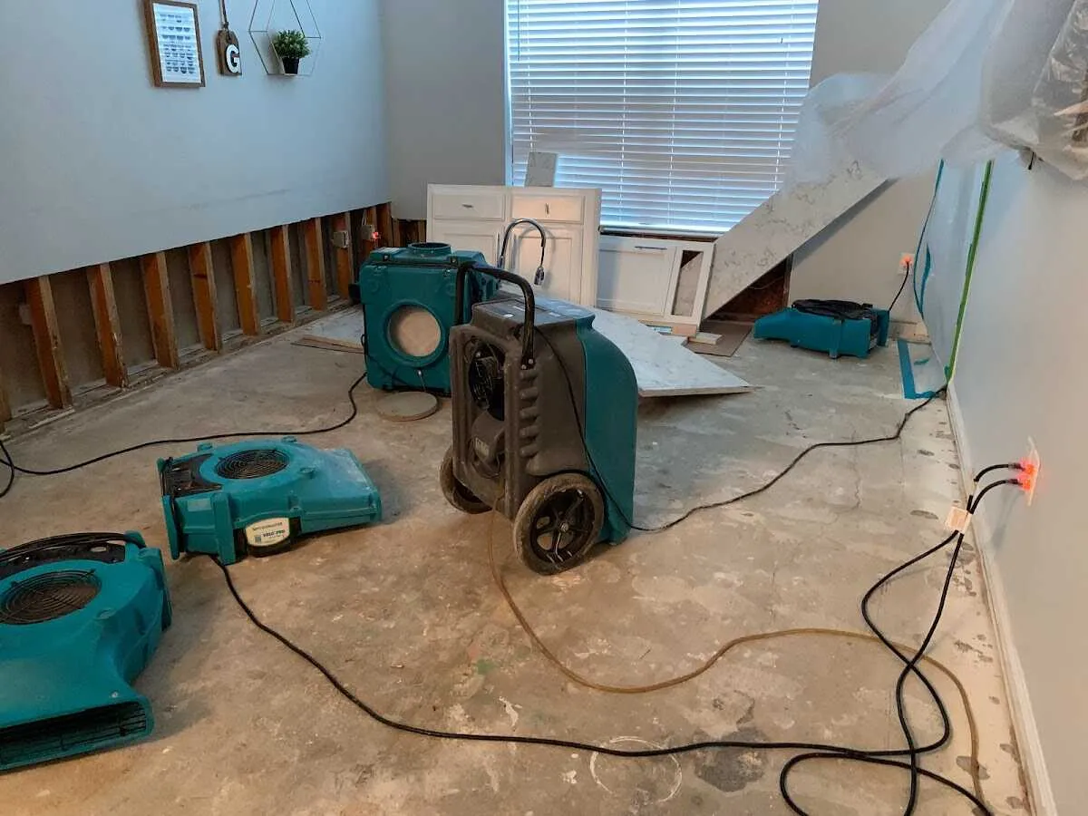 Dehumidifier in flood-cut room for Water Damage Restoration in White